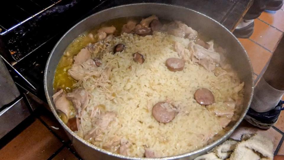 A pot of chicken bog cooked by Conway, S.C. chef Larry Dickerson is removed from the oven of Donzelle’s restaurant. January 25, 2022.