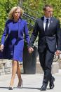 <p>Walking to a welcome ceremony in Canada wearing a royal blue dress, matching coat, and floral white pumps. </p>