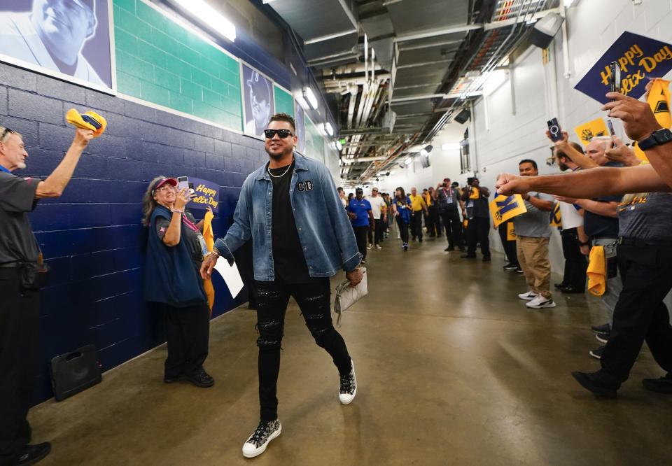 Former Seattle Mariners pitcher Felix Hernandez is greeted by a tunnel of cheering staff as he arrives for a media availability before a baseball game between the Mariners and the Baltimore Orioles, Friday, Aug. 11, 2023, in Seattle. Hernandez will be inducted into the Mariners Hall of Fame on Aug. 12. (AP Photo/Lindsey Wasson)