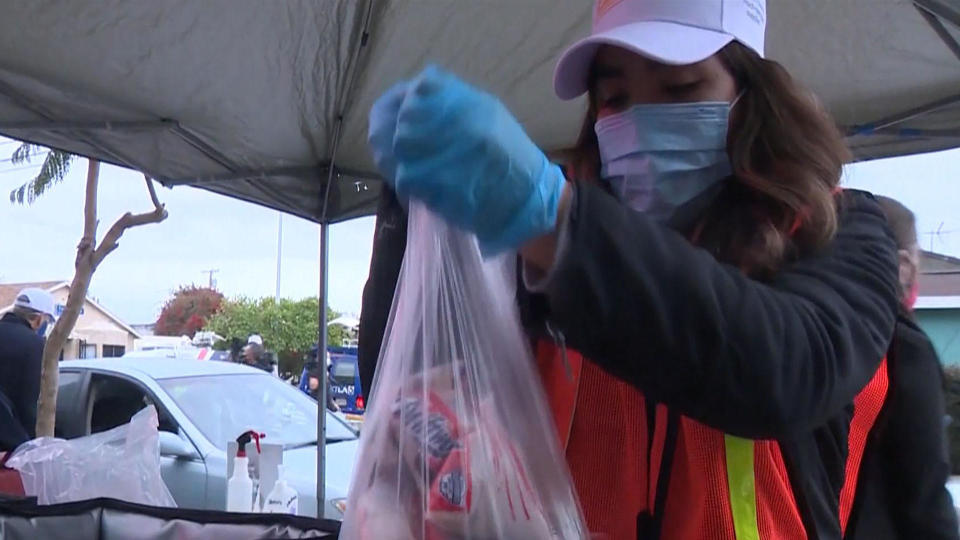 A worker at a food bank in Los Angeles. / Credit: CBS News