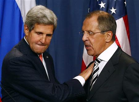U.S. Secretary of State John Kerry (L) and Russian Foreign Minister Sergei Lavrov shake hands after making statements following meetings regarding Syria, at a news conference in Geneva in this September 14, 2013 file picture. REUTERS/Ruben Sprich