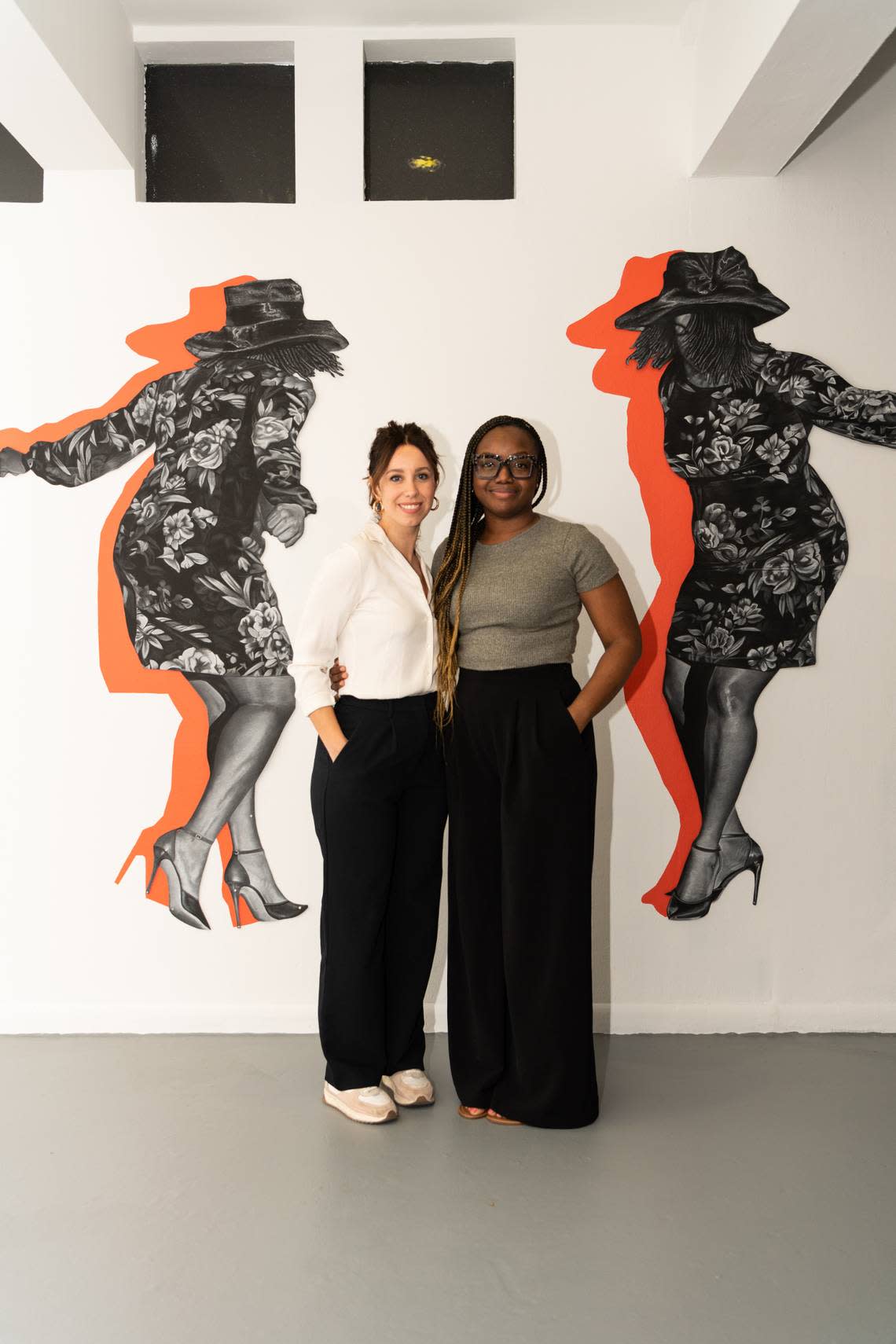 Curator Laura Novoa, left, and artist Chris Friday, right, at ‘Good Times,’ an exhibition of Friday’s new artwork on display at Oolite Arts on Lincoln Road.