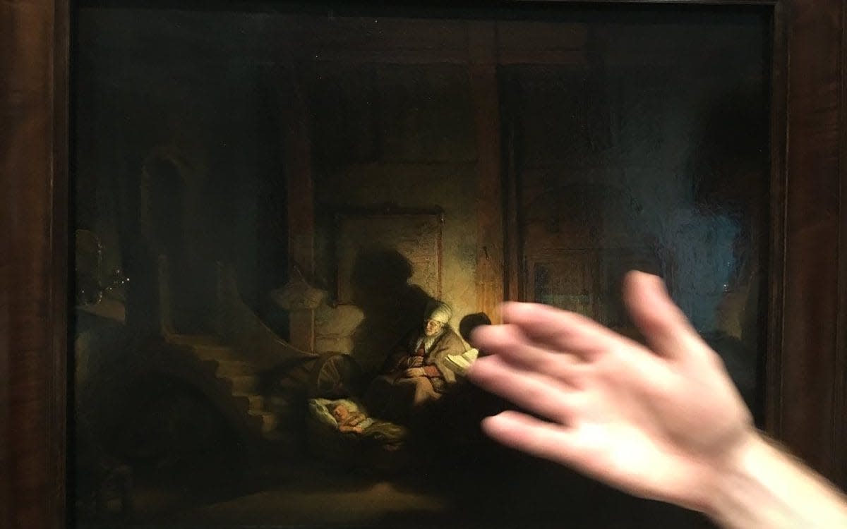 Dr Bendor Grosvenor shared this photograph of an official's hand obstructing his view of a Rembrandt painting - Dr Bendor Grosvenor