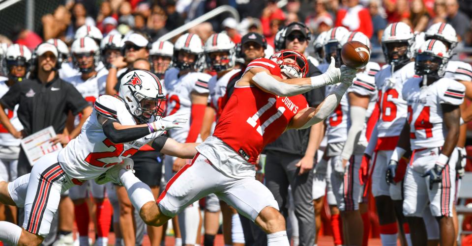 St. John's wide receiver Jimmy Buck stretches to try to make a catch during the first half of the game Saturday, Sept. 10, 2022, against UW-River Falls at Clemens Stadium in Collegeville.