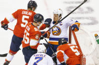 New York Islanders left wing Anders Lee, rear right, is wrestled out of the goal by Florida Panthers defenseman Aaron Ekblad (5) during a scramble for the puck in the first period of an NHL hockey game in Toronto, Friday, Aug. 7, 2020. (Chris Young/The Canadian Press via AP)