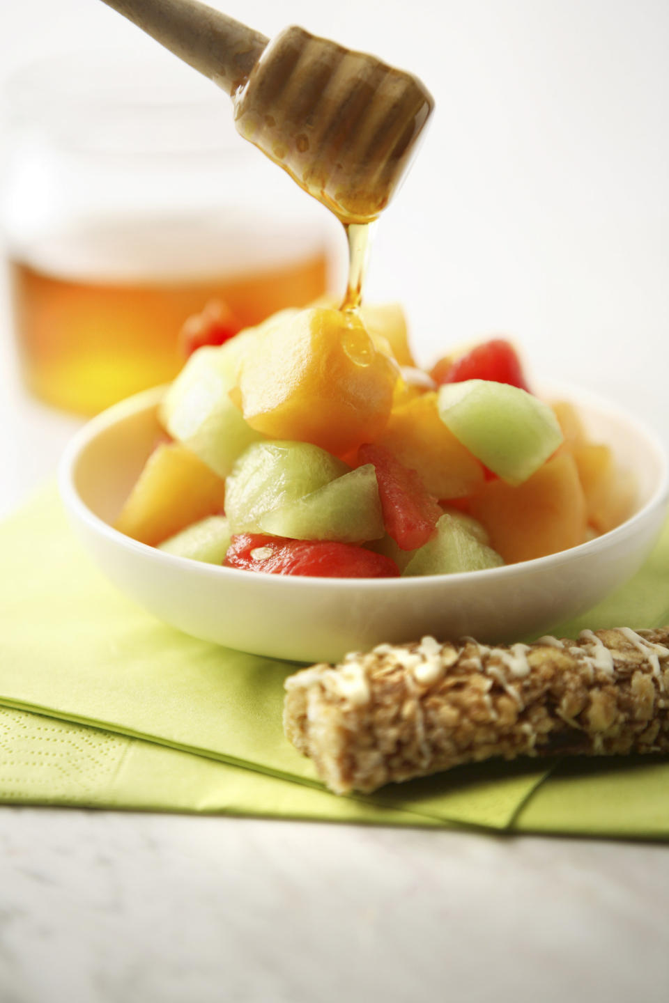 honey being poured on fruit