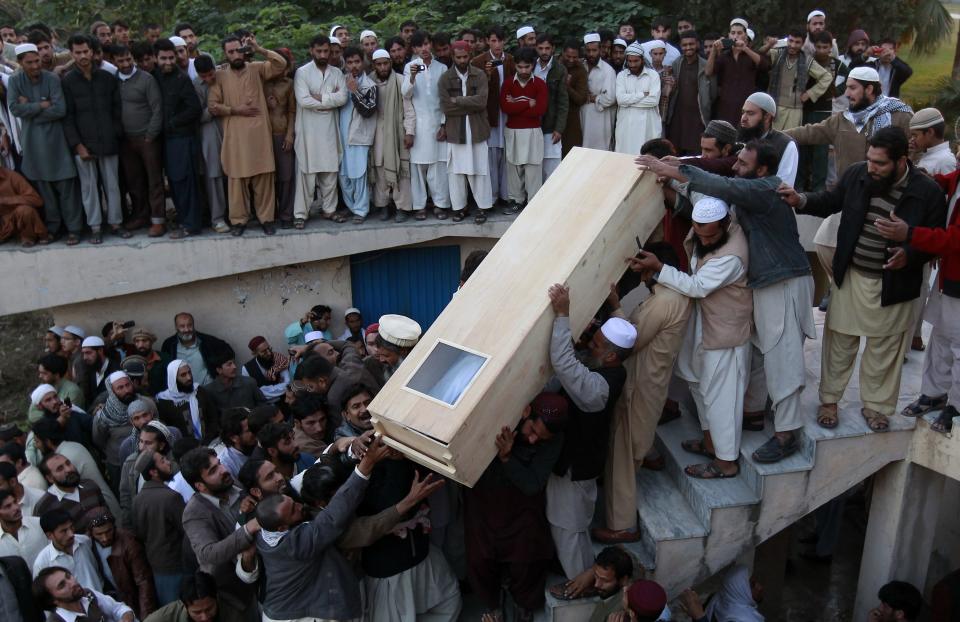 Sunni Muslims carry the casket of a fellow Sunni who was killed in Friday's sectarian clashes during a Muharram procession, at Laiquat Bagh in Rawalpindi