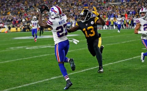 Buffalo Bills cornerback Tre'Davious White (27) intercepts a pass from Pittsburgh Steelers quarterback Devlin Hodges (not shown) intended for Steelers wide receiver James Washington (13) during the first half of an NFL football game in Pittsburgh, Sunday - Credit: AP