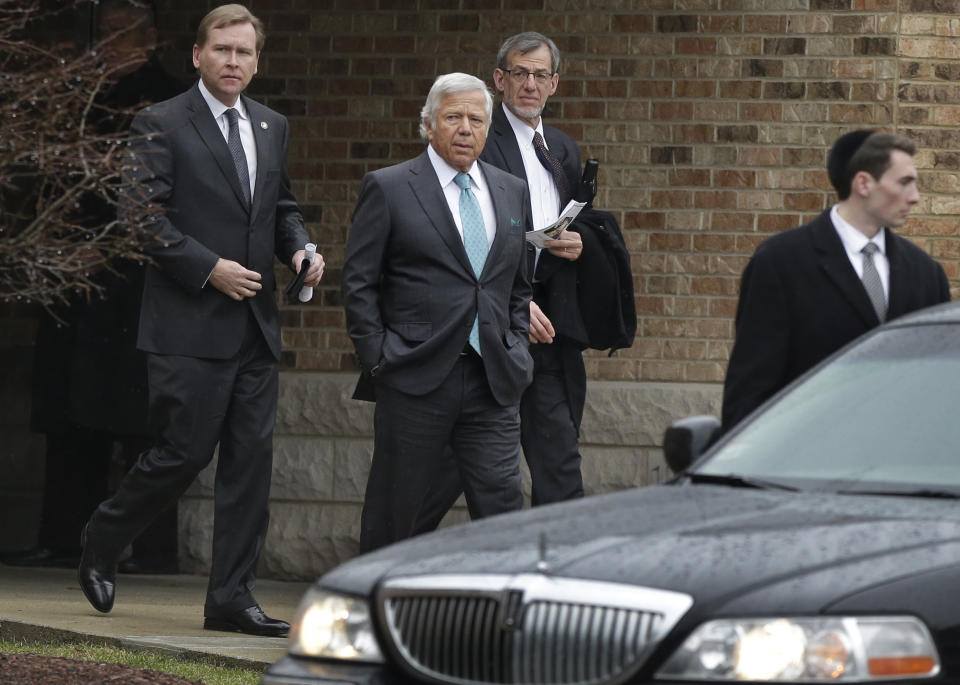 Robert Kraft, owner of the New England Patriots NFL football team, center left, departs funeral services for 17-year-old Sam Berns at Temple Israel, Tuesday, Jan. 14, 2014, in Sharon, Mass. Berns died Friday after complications from Hutchinson-Gilford progeria syndrome, commonly known as progeria, a rare genetic condition that accelerates the aging process. Other men in photo are unidentified. (AP Photo/Steven Senne)