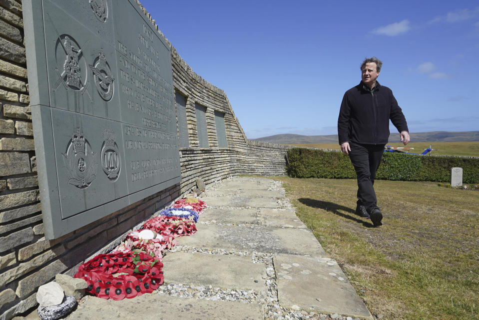 Foreign Secretary Lord David Cameron visits San Carlos Cemetery on the Falkland Islands, during his high-profile visit to demonstrate they are a "valued part of the British family" amid renewed Argentinian calls for talks on their future, in Stanley, Falkland Islands, Britain, on Monday Feb. 19, 2024. (Stefan Rousseau/PA via AP)