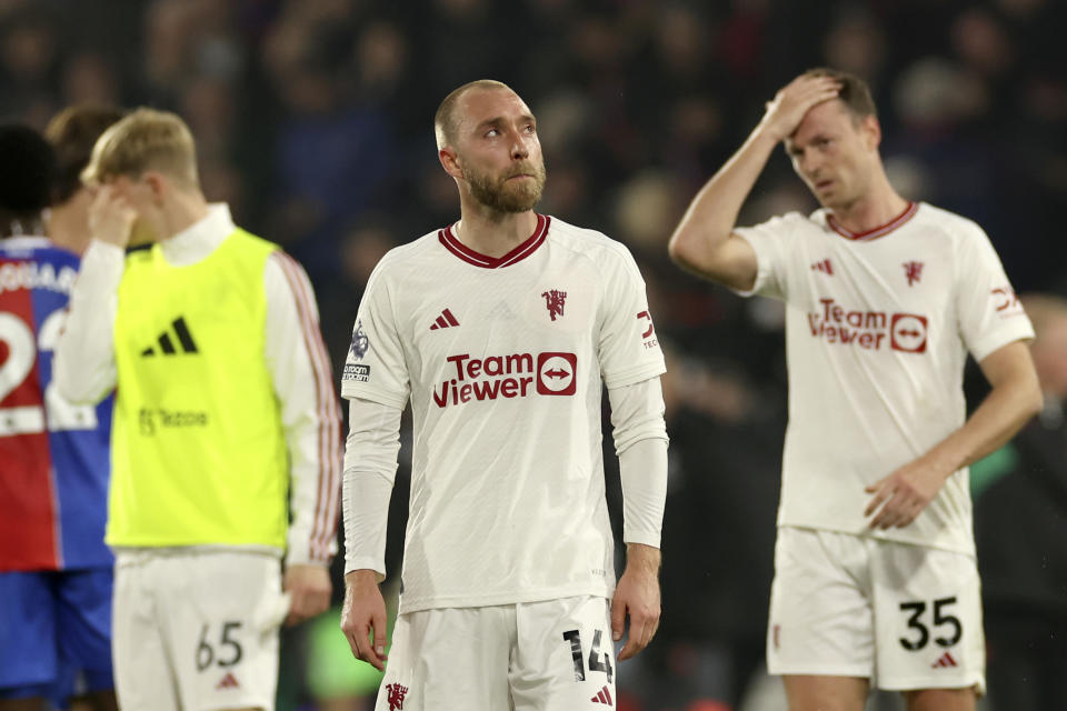 Manchester United's Toby Collyer, left, Manchester United's Christian Eriksen, centre, Manchester United's Jonny Evans react disappointed after the English Premier League soccer match between Crystal Palace and Manchester United at Selhurst Park stadium in London, England, Monday, May 6, 2024. (AP Photo/Ian Walton)