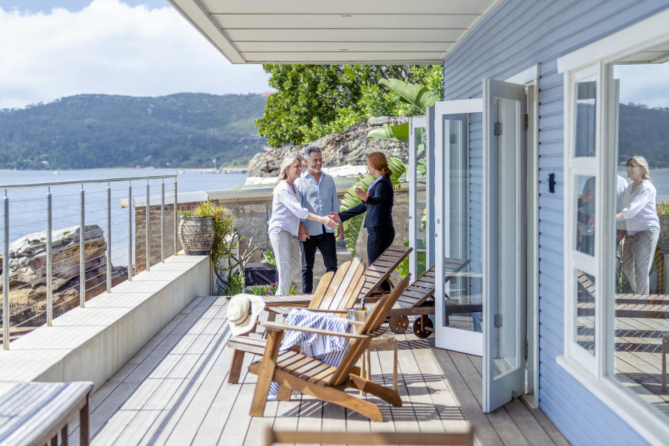 couple touring a timeshare next to the ocean