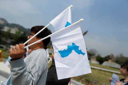 Students hold Korean Unification Flags during a pro-unification rally ahead of the upcoming summit between North and South Korea in Seoul, South Korea April 26, 2018. REUTERS/Jorge Silva