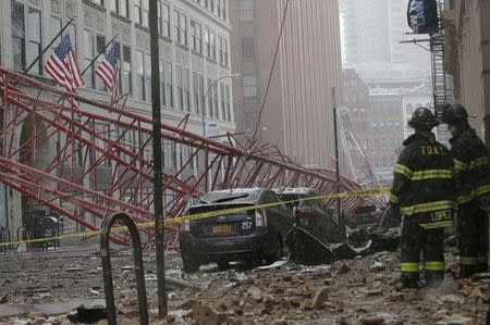 Emergency crews survey a massive construction crane collapse on a street in downtown Manhattan in New York February 5, 2016. REUTERS/Brendan McDermid