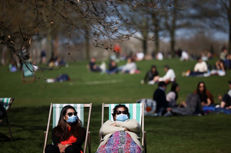 FILE PHOTO: People relax during sunny weather in Hyde Park, amid the coronavirus disease (COVID-19) outbreak, in London