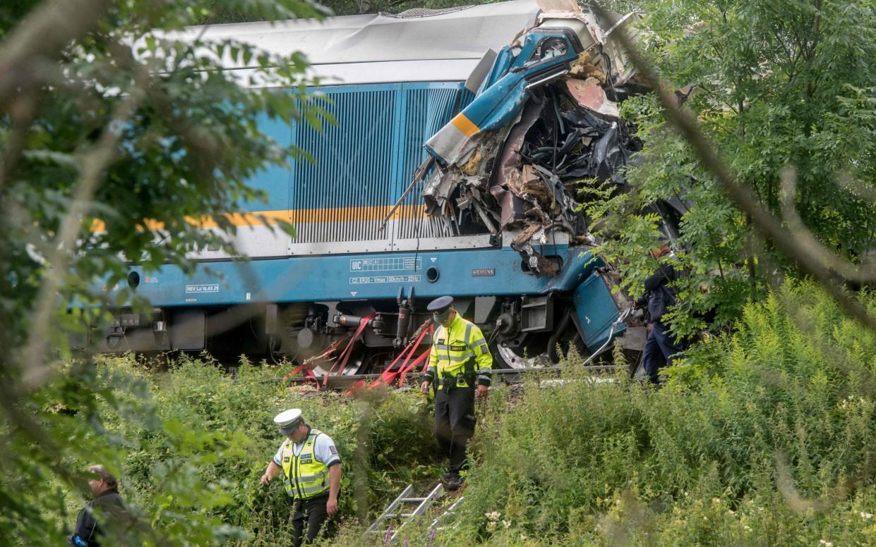 Policemen walk in front of one of two collided trains - MICHAL CIZEK 