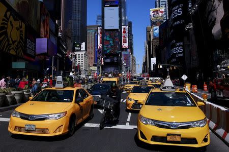 New York City taxi cabs drive through Times Square in New York March 29, 2016. REUTERS/Lucas Jackson