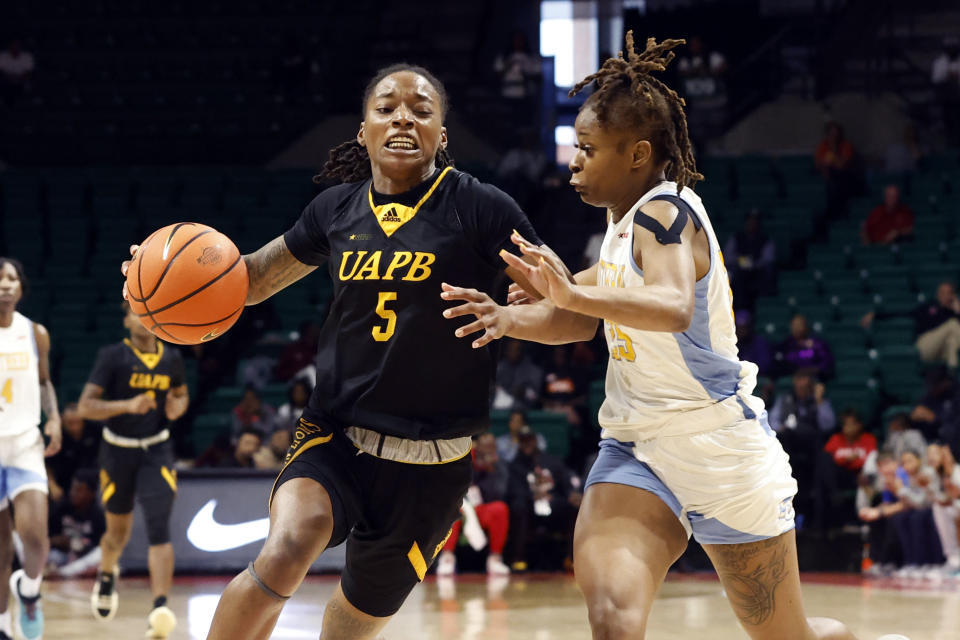 Arkansas-Pine Bluff guard Jelissa Reese (5) drives to the basket around Southern guard Genovea Johnson (25) during the second half of an NCAA college basketball game in the championship of the Southwestern Athletic Conference Tournament, Saturday, March 11, 2023, in Birmingham, Ala. (AP Photo/Butch Dill)