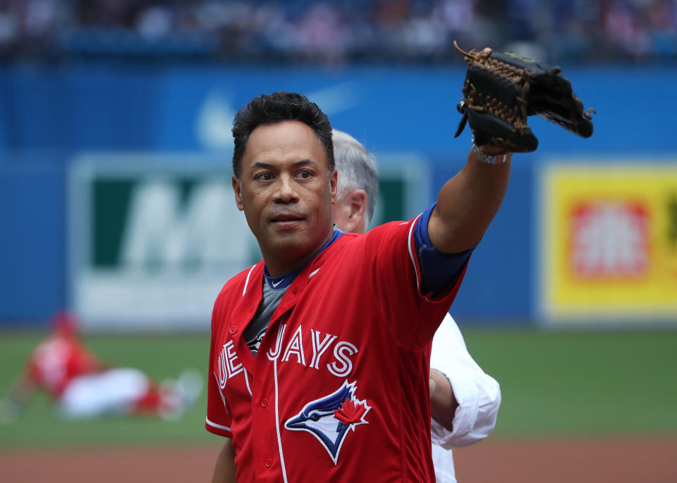 TORONTO, CANADA - AUGUST 28: Hall of Fame player Roberto Alomar of the Toronto Blue Jays acknowledges fans after catching a ceremonial first pitch from former general manager and Hall of Famer Pat Gillick before the start of MLB game action against the Minnesota Twins on August 28, 2016 at Rogers Centre in Toronto, Ontario, Canada. (Photo by Tom Szczerbowski/Getty Images)