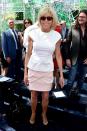 <p>In a white top and pink skirt with black heels while attending the Christian Dior fashion show in Paris, France.</p>