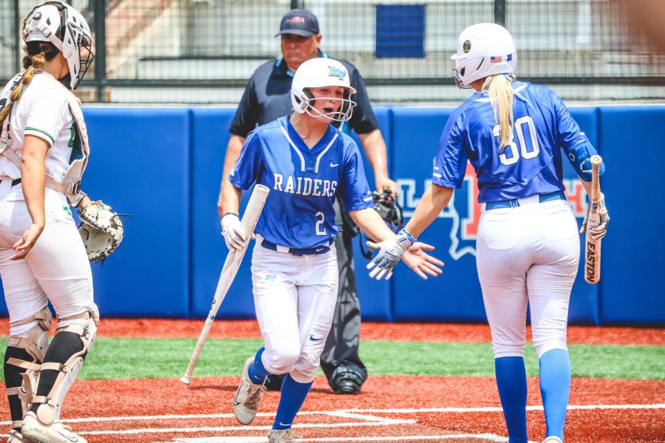 MTSU's Shelby Sargent (2) and Shelby Echols (30) celebrate Sargent scoring a run during Saturday's Conference USA championship game vs. North Texas.