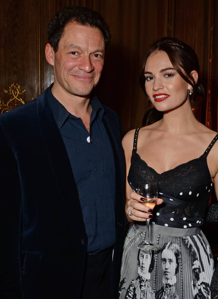 Dominic West and Lily James stand close at an event