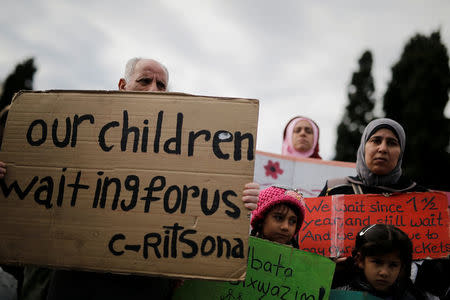 Refugees, some announcing a hunger strike, hold placards during a protest as they seek reunification with family members in Germany, near the parliament building in Athens, Greece, November 1, 2017. REUTERS/Alkis Konstantinidis