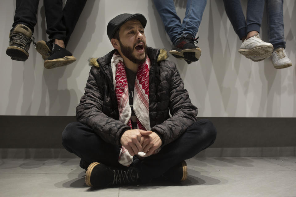 An anti-government protester, one of more than 20, chants slogans as they occupy the Hamra branch of BLC Bank Dec. 28, 2019 in Beirut, Lebanon. Banks have imposed weekly limits on withdrawals of U.S. dollars amid a shortage in liquidity and as the country grapples with its worst economic and financial crisis since the end of the 1975-90 civil war. The country has been without a prime minister since ongoing mass protests forced the resignation of Premier Saad Hariri on Oct. 29. (AP Photo/Maya Alleruzzo)(AP Photo/Maya Alleruzzo)