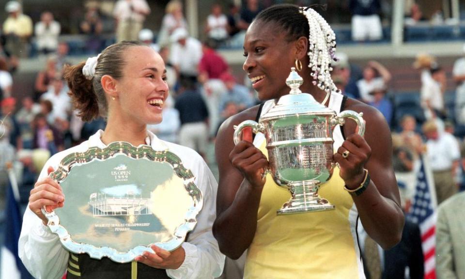 Serena Williams holds the US Open trophy in 1999 alongside runner-up Martina Hingis