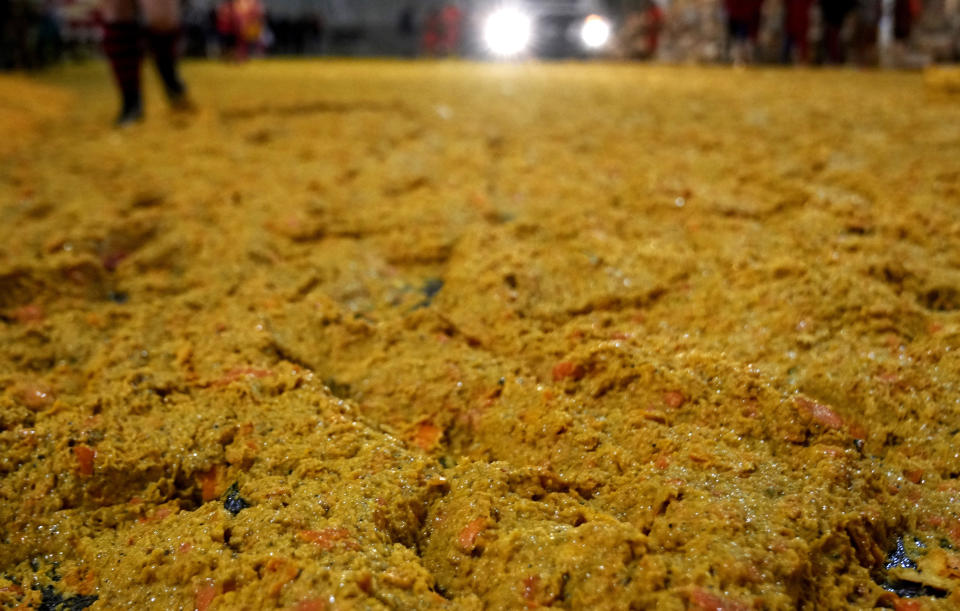 Smashed oranges are scattered on the ground following the 'Battle of the Oranges" where people pelt each other with oranges as part of Carnival celebrations in the northern Italian Piedmont town of Ivrea, Italy, Tuesday, Feb. 13, 2024. (AP Photo/Antonio Calanni)