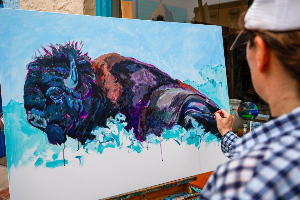 Megan Wimberley paints on May 27 at the Paseo Art Festival in Oklahoma City.