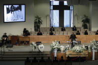 FILE - In this June 30, 2020, file photo, a pastor eulogizes Robert Fuller, pictured top left, during his funeral in his honor in Littlerock, Calif. A police investigation confirmed suicide was the cause of death of Fuller, a Black man found hanging from a tree in a Southern California city park last month, authorities said Thursday, July 9, 2020. (AP Photo/Marcio Jose Sanchez, File)