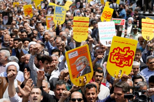 Iranians hold anti-US placards and shout slogans during a demonstration after Friday prayers in the capital Tehran on May 11, 2018