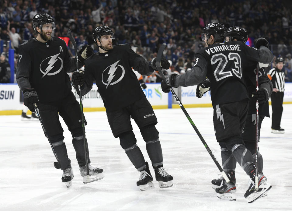 Tampa Bay Lightning defenseman Victor Hedman (77), defenseman Erik Cernak (81) and center Carter Verhaeghe (23) celebrate Verhaeghe's goal during the second period of an NHL hockey game against the Philadelphia Flyers, Saturday, Feb. 15, 2020, in Tampa, Fla. (AP Photo/Jason Behnken)