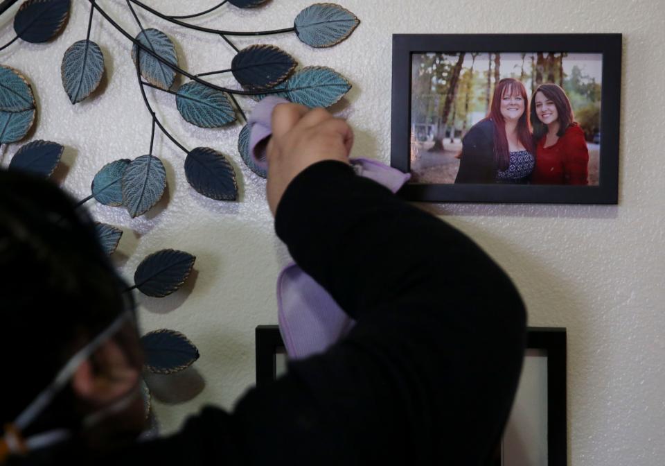 Volunteers with Michelle's Love clean Lisa Painter's home on Saturday in Salem.