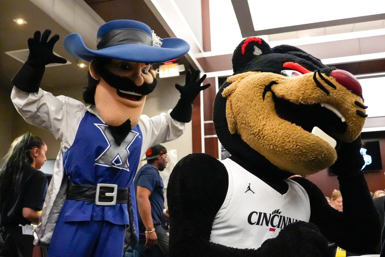 The Xavier Musketeer mascot attempts to scare the Cincinnati Bearcats mascot during Skyline Chili’s Crosstown Shootout Party on Thursday, Dec. 7, 2023, at Skyline Chili in Downtown Cincinnati. The Crosstown Shootout, an iconic yearly mens basketball game in its 93rd year between the Cincinnati Bearcats and Xavier Musketeers, will be held on Saturday, Dec. 9, 2023, at the Cintas Center.