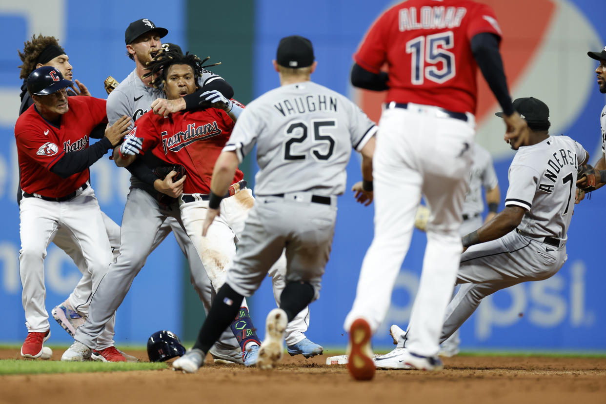 CLEVELAND, OH - AUGUST 05: Jose Ramirez #11 of the Cleveland Guardians (fourth from left) is restrained as Tim Anderson #7 of the Chicago White Sox falls to the ground during a fight in the sixth inning at Progressive Field on August 05, 2023 in Cleveland, Ohio. (Photo by Ron Schwane/Getty Images)