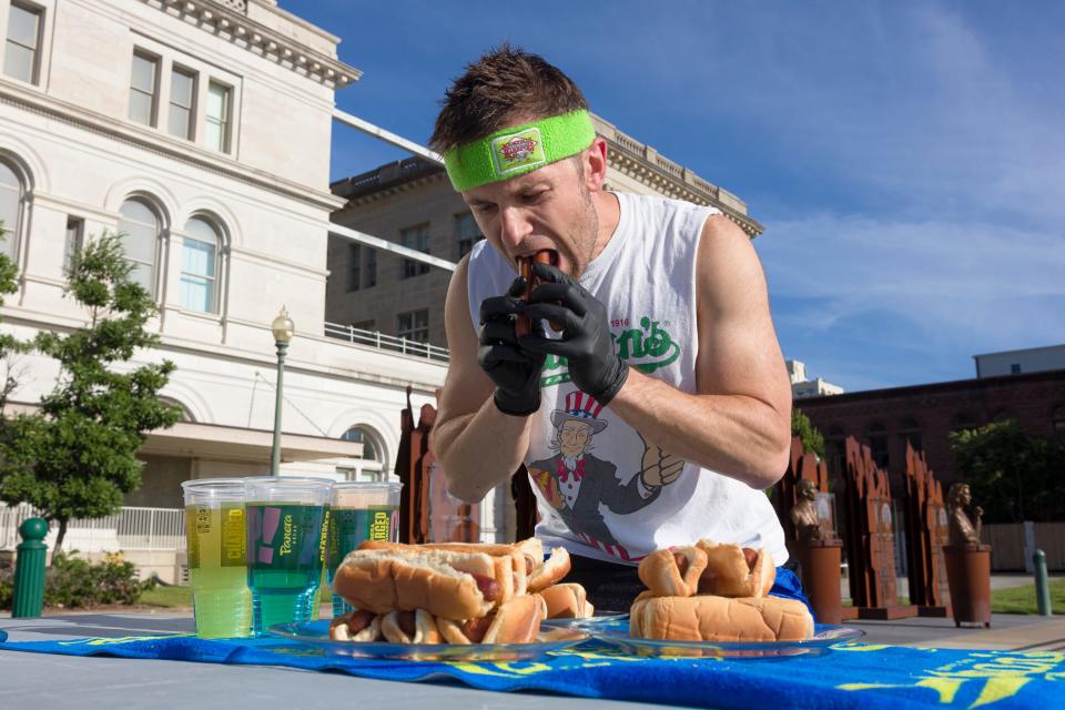 Competitive eater Brett Healey trains for the upcoming July 4th Nathan's Hot Dog Eating Contest outside the University of Memphis Law School in Downtown Memphis on Monday, June 27, 2022.