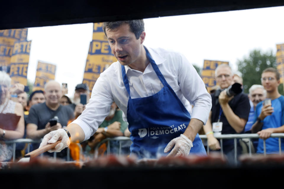 Democratic presidential candidate Pete Buttigieg works the grill during the Polk County Democrats Steak Fry, Saturday, Sept. 21, 2019, in Des Moines, Iowa. (AP Photo/Charlie Neibergall)