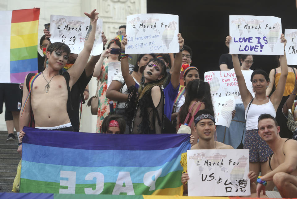 Participants march during the "Taiwan Pride March for the World!" at Liberty Square at the CKS Memorial Hall in Taipei, Taiwan, Sunday, June 28, 2020. This year marks the first Gay Pride march in Chicago 1970, and due to the COVID-19 lockdown, Taiwan is one of the very few countries to host the world's only physical Gay Pride. (AP Photo/Chiang Ying-ying)