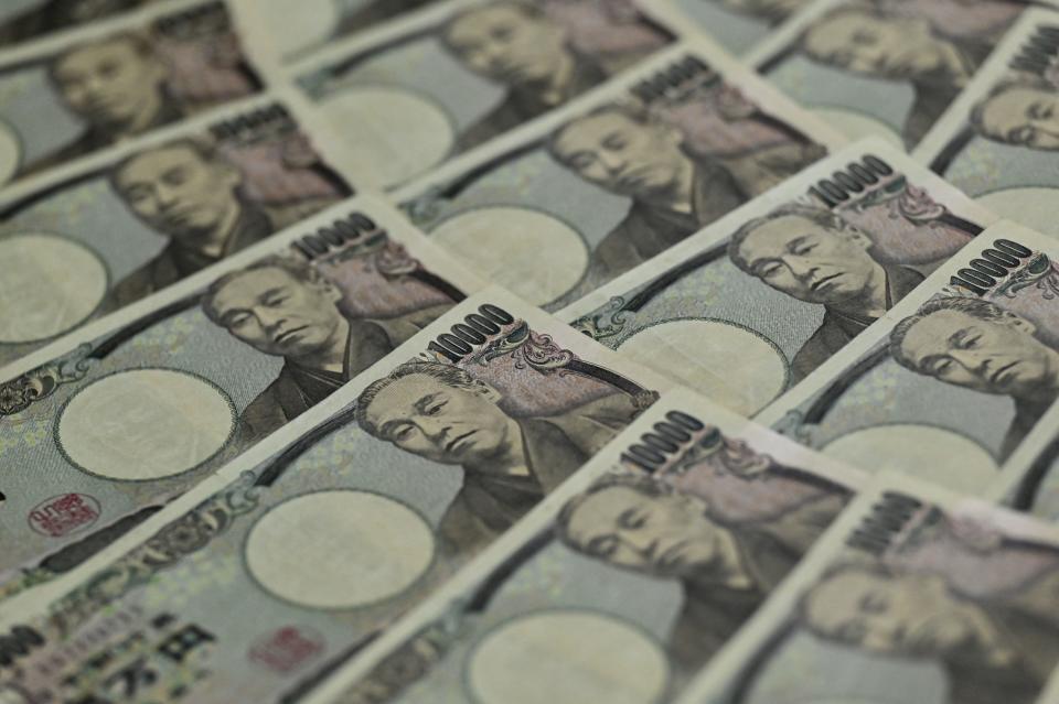 This photo illustration taken on September 24, 2022 shows Japanese 10,000 yen notes (apprx. 69 USD) on display in Tokyo. - Japan's finance ministry on September 22 intervened in the currency market to bolster the yen, which has plummeted against the US dollar in recent months on the widening policy gap between the US and Japanese central banks. (Photo by Richard A. Brooks / AFP) (Photo by RICHARD A. BROOKS/AFP via Getty Images)