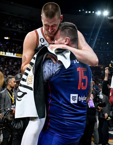 <p>Aaron Ontiveroz/The Denver Post/Getty</p> Nikola Jokic and his brother, Strahinja, after the fourth quarter of the Nuggets' 94-89 NBA Finals in 2023