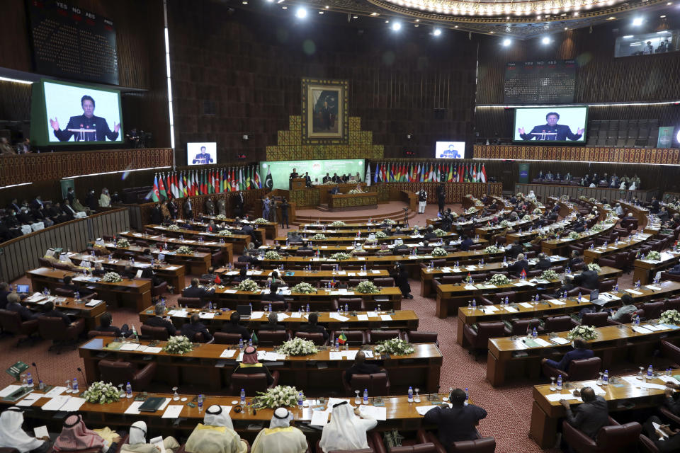 Pakistan's Prime Minister Imran Khan, center, speaks during the 17th extraordinary session of Organization of Islamic Cooperation (OIC) Council of Foreign Ministers, in Islamabad, Pakistan, Sunday, Dec. 19, 2021. The economic collapse of Afghanistan, already teetering dangerously on the edge, would have a "horrendous" impact on the region and the world, successive speakers warned Sunday at the start of a one-day summit of foreign ministers. (AP Photo/Rahmat Gul)