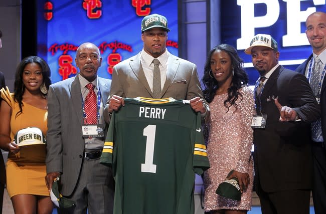 Southern California's Nick Perry poses for photographs with loved ones after being selected 28th overall by the Green Bay Packers in the first round of the NFL football draft at Radio City Music Hall, Thursday, April 26, 2012, in New York. (AP Photo/Jason DeCrow)