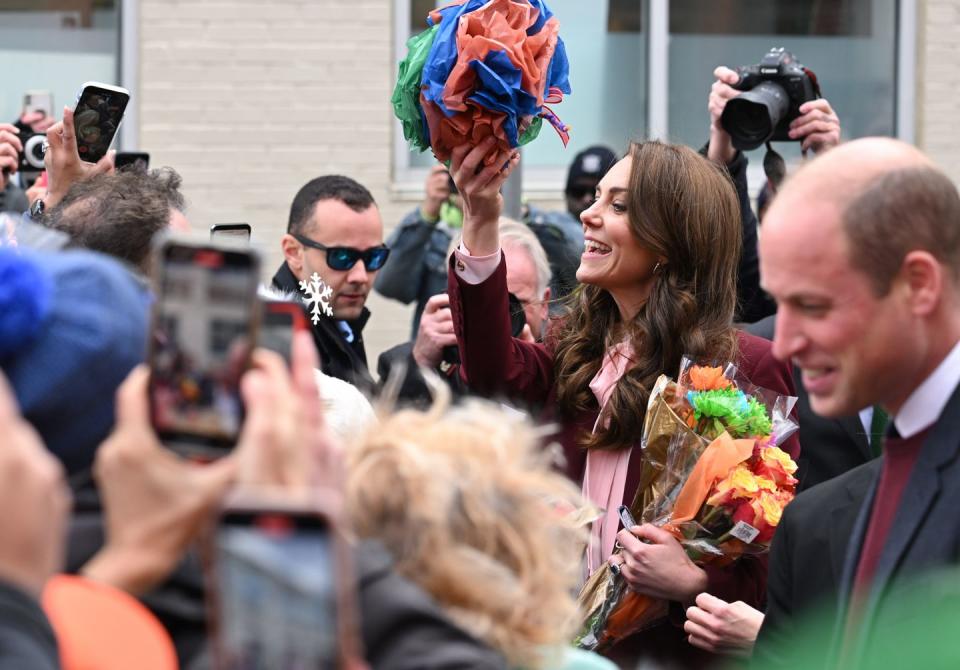 <p>The couple accepts gifts during a visit to Roca, a non-profit organization focusing on high-risk young people at the center of urban violence.</p>