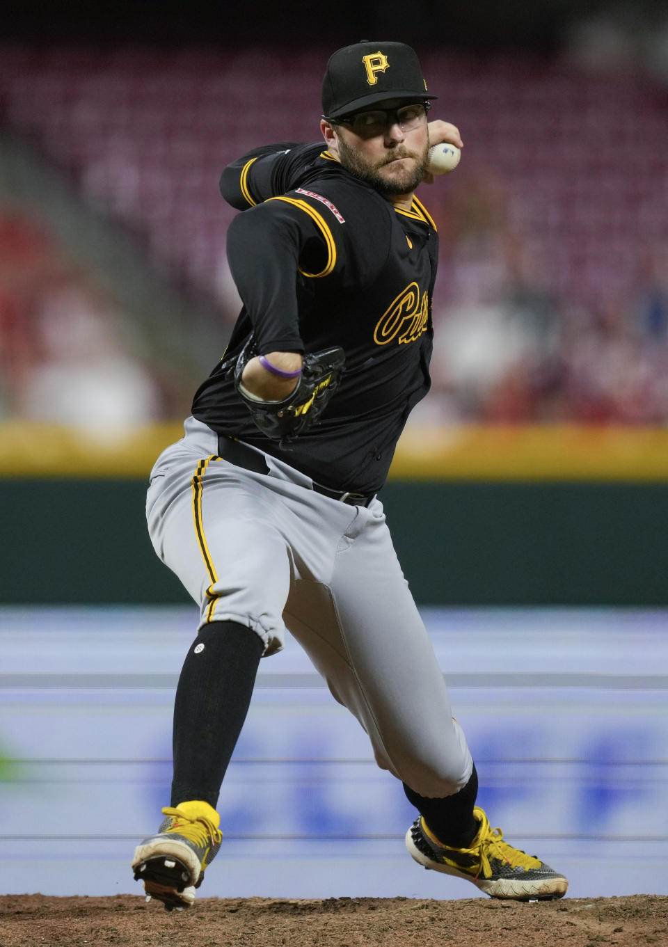Pittsburgh Pirates pitcher Josh Fleming throws to a Cincinnati Reds batter during the ninth inning of a baseball game Tuesday, June 25, 2024, in Cincinnati. The Pirates won 9-5. (AP Photo/Carolyn Kaster)