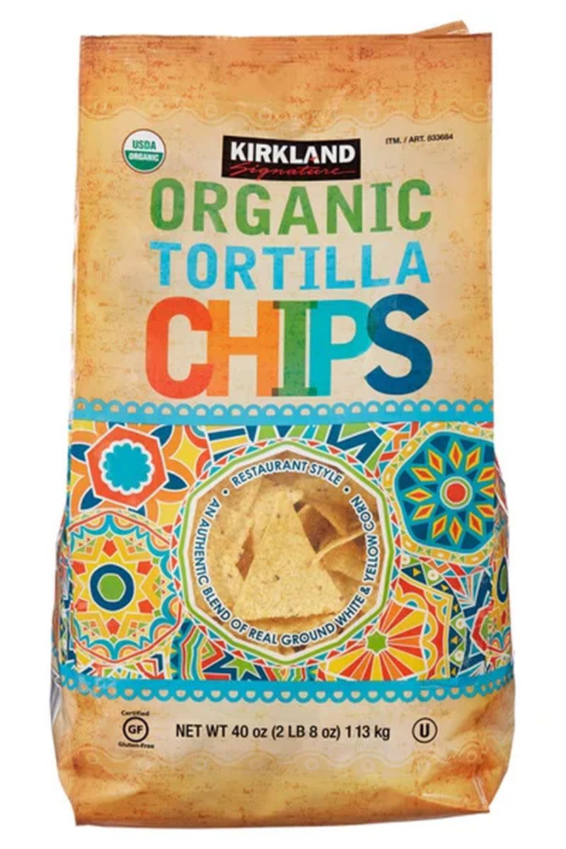 A bag of Kirkland Signature Organic White & Yellow Corn Tortilla Chips against a white background