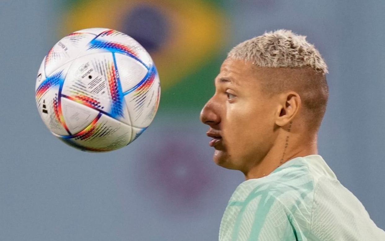 Richarlison looking at a football - World Cup 2022 TV schedule: How to watch England and the matches live today - Andre Penner/AP