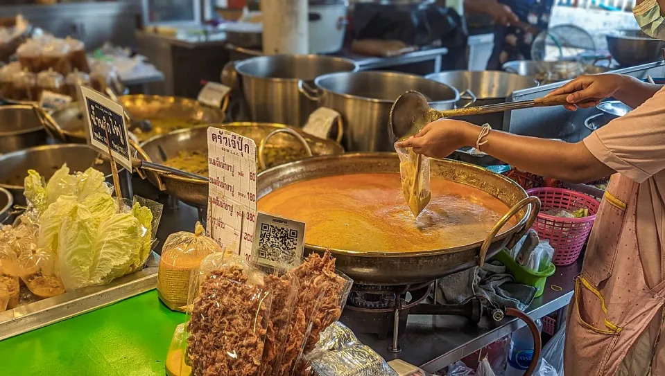 Woman bagging curry soup