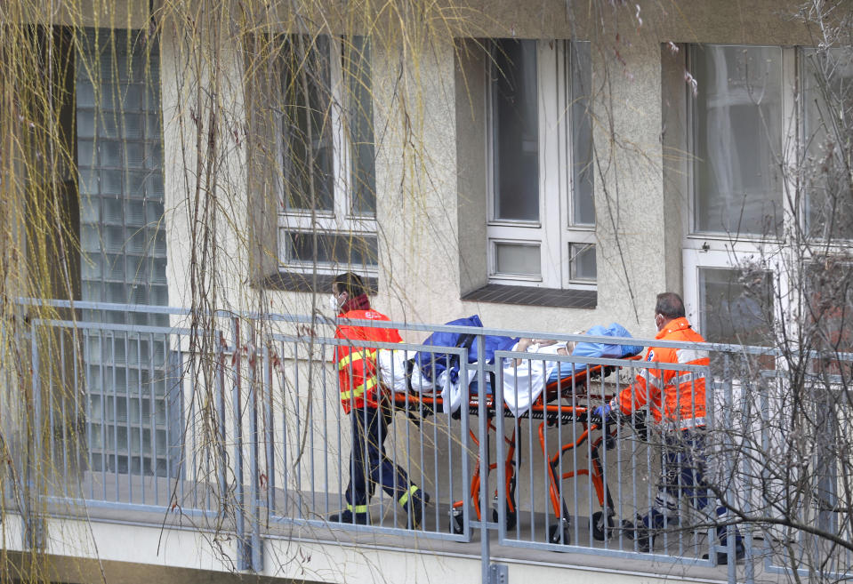 Healthcare workers move a patient at the infectious ward of the Bulovka hospital in Prague, Czech Republic, Wednesday, Feb. 24, 2021. The Czech prime minister Andrej Babis said the pandemic situation in one of the hardest-hit country in the European Union, is "extremely serious" and his government will have to impose more restrictive measures to slow down the spread of the coronavirus. (AP Photo/Petr David Josek)